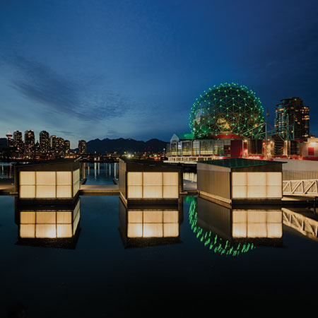 Indirect fixtures inside semi-translucent storage sheds make the buildings glow like Chinese paper lanterns along the waterfront.