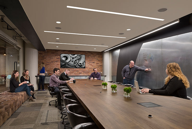Rather then whiteboard, a stainless steel writing wall offers an unusual conference room flourish.