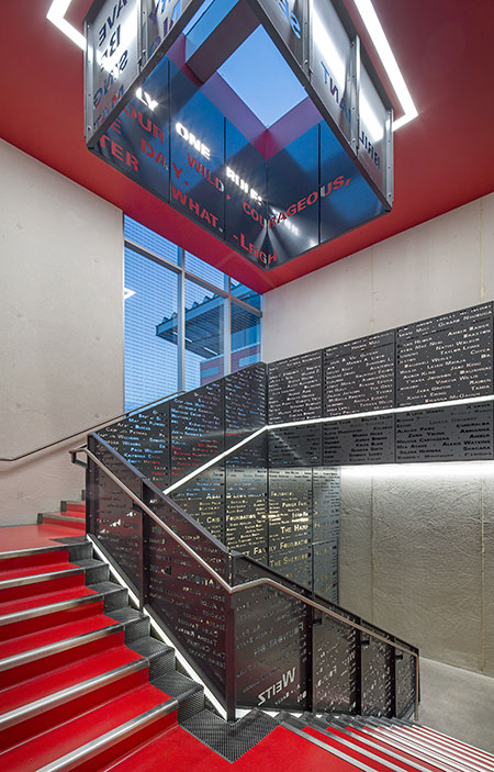 LED tapelight integrated into the donor staircase and leading up to a skylight is a metaphor for girls being uplifted by the nonprofit’s programs.