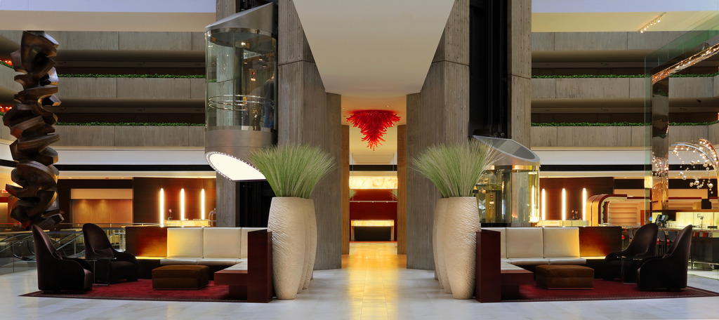 Accentuate the Positive 2 Accentuate the Positive article | At the Hyatt Regency O’Hare in Chicago, backlighting of the stone wall in the registration area provides both a pleasing aesthetic and wayfinding to the area | Photo: Courtesy of Hyatt